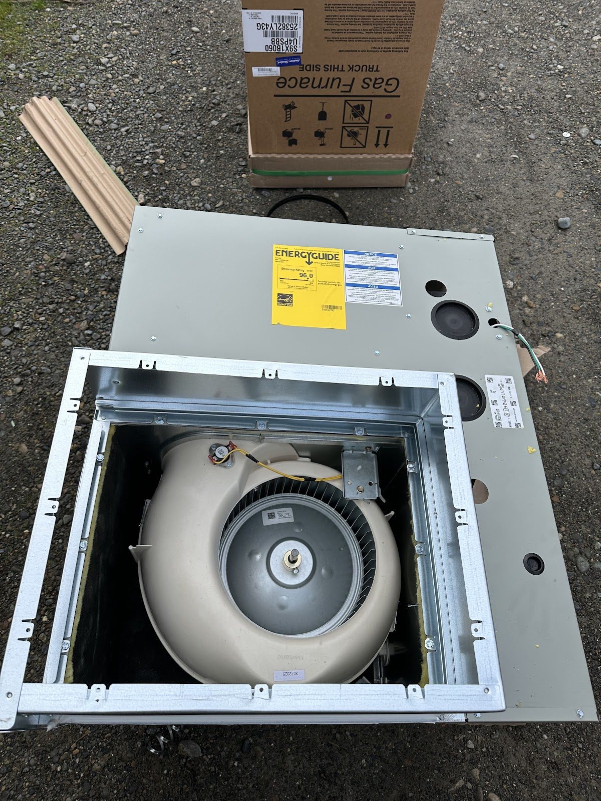 New American Standard gas furnace staged in the driveway before install at a South Sound home