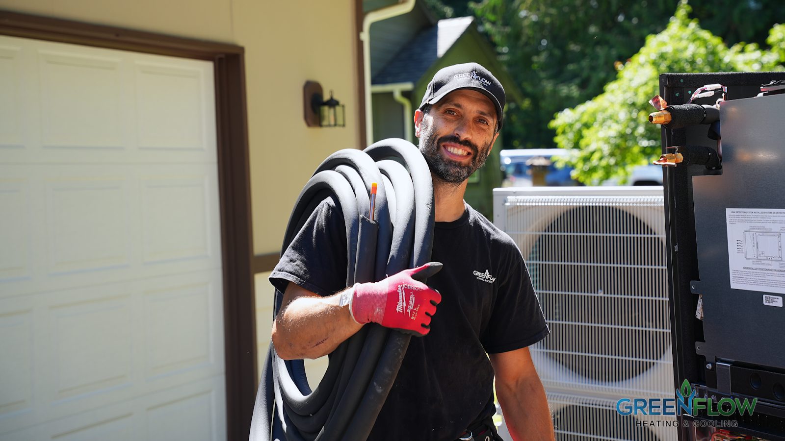 GreenFlow technician carrying a new refrigerant line set on the doorstep of a Tacoma install