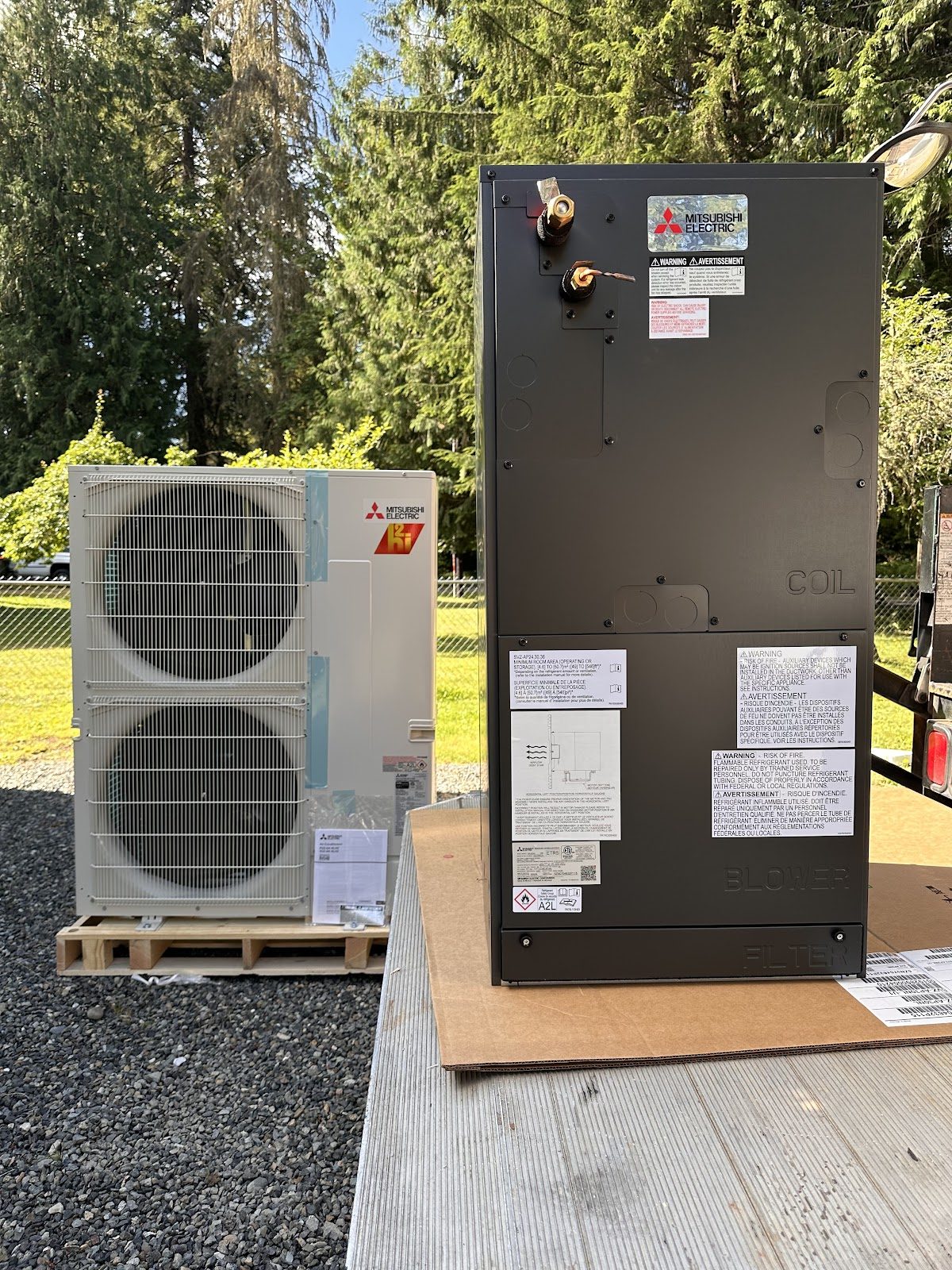 New Mitsubishi outdoor condenser and vertical air handler staged for install
