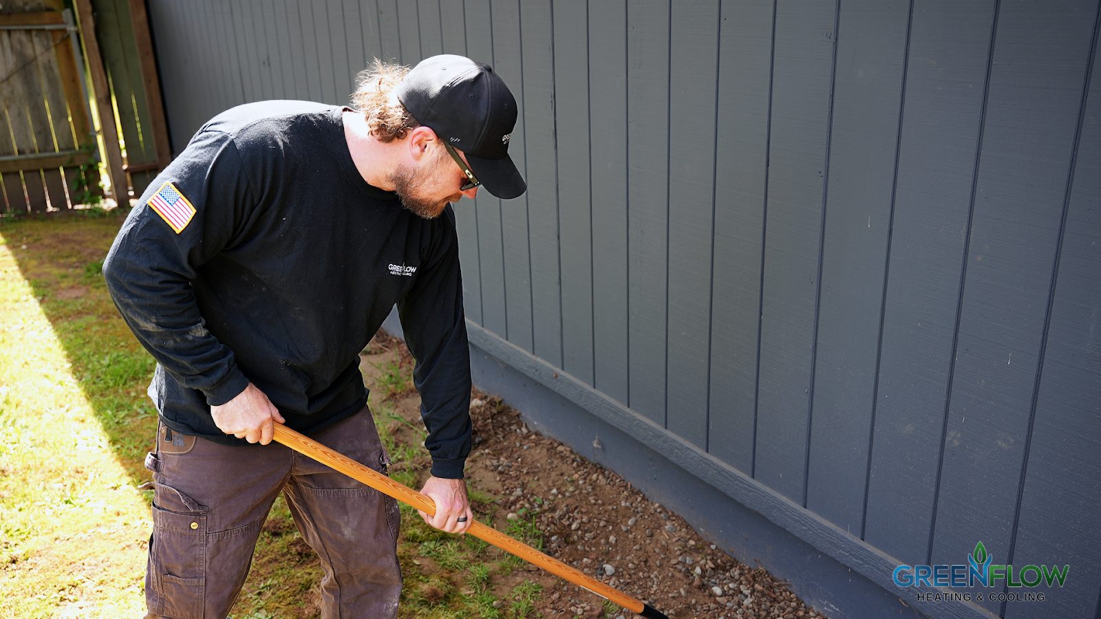 GreenFlow crew member cleaning up around a residential jobsite in Pierce County