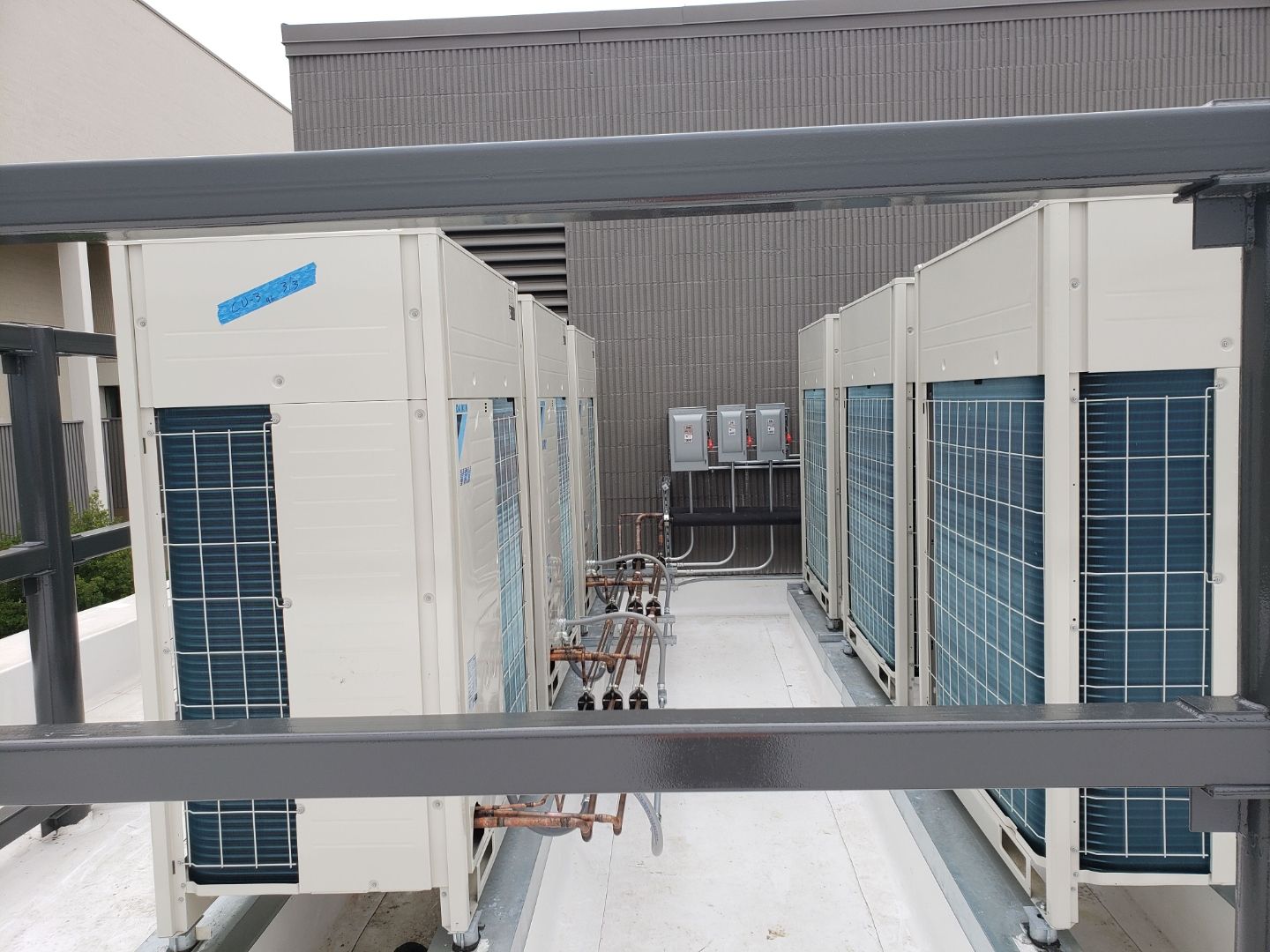 Daikin VRV commercial condensing unit array with copper refrigerant lines installed by GreenFlow on a South Sound commercial rooftop