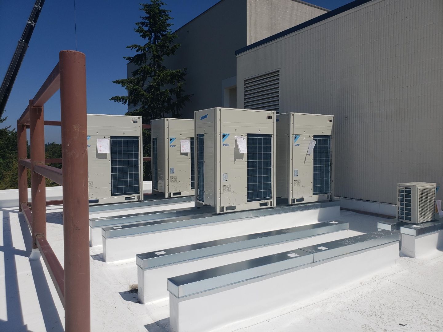 Four Daikin VRV outdoor condensing units mounted on steel curbs on a commercial rooftop installed by GreenFlow near Tacoma