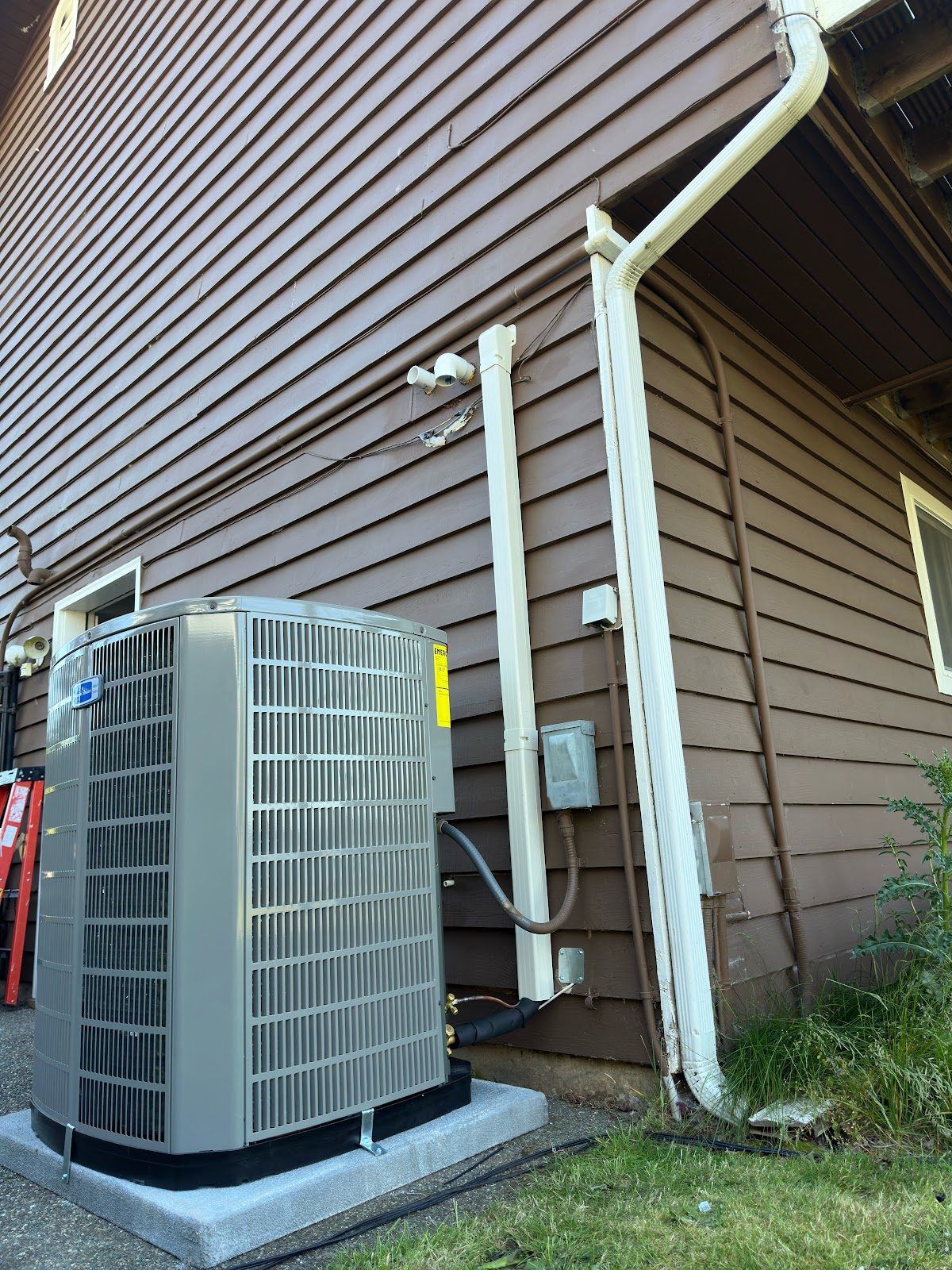 American Standard outdoor AC condenser installed on concrete pad at a Tacoma home