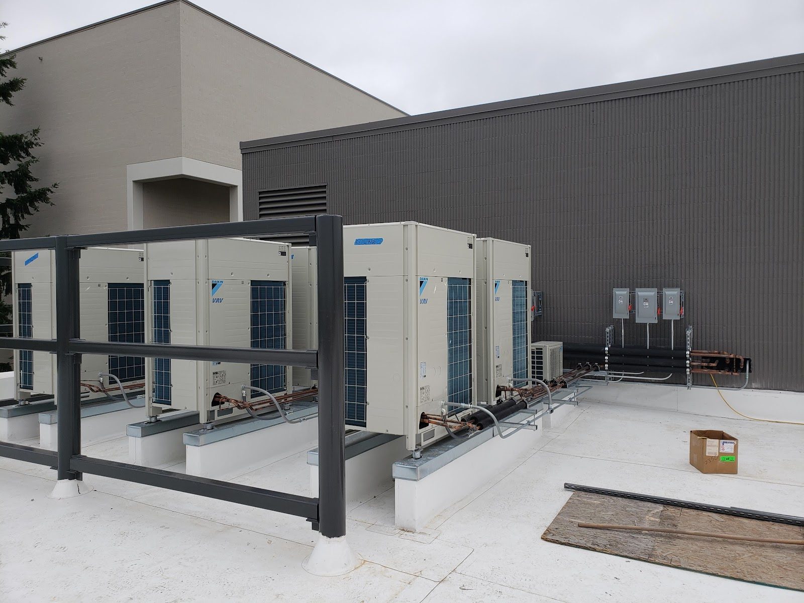Commercial Daikin VRV multi-unit heat pump array with protective bollard fencing