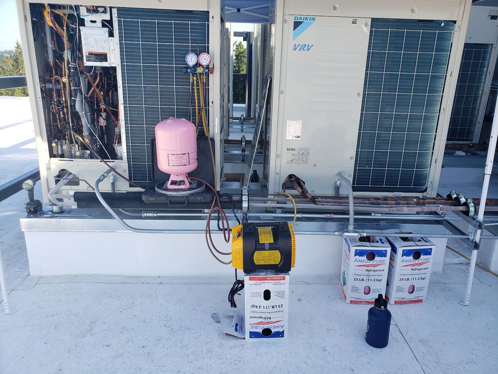 Commercial Daikin VRV rooftop install with refrigerant charging equipment mid-commissioning