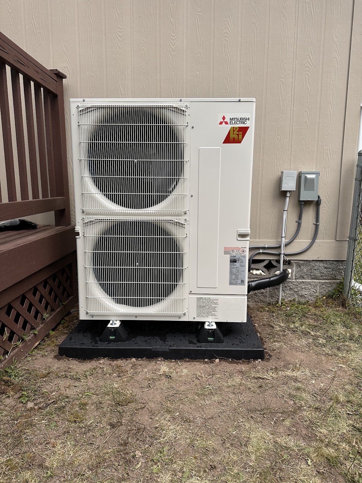 Mitsubishi hyper-heat outdoor unit installed on ground pad at a South Sound residence