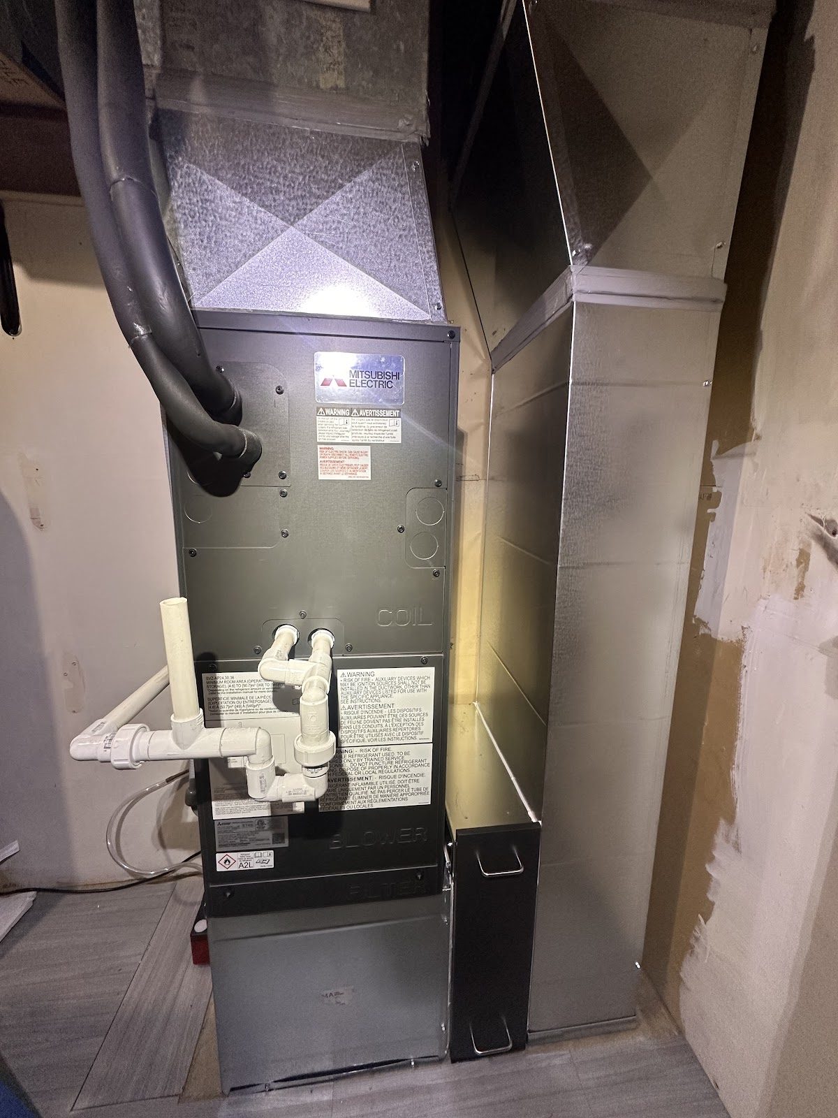 Vertical air handler installed in a residential mechanical closet