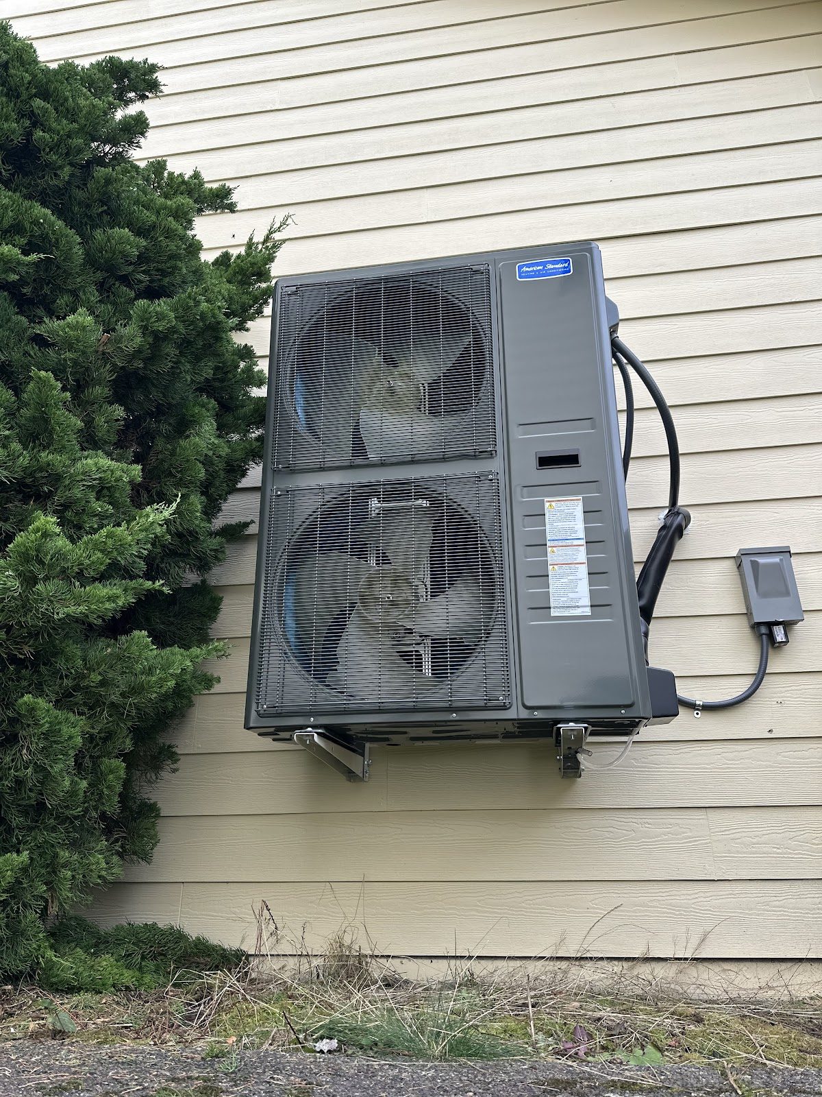 American Standard wall-mounted side-discharge heat pump installed to save yard space