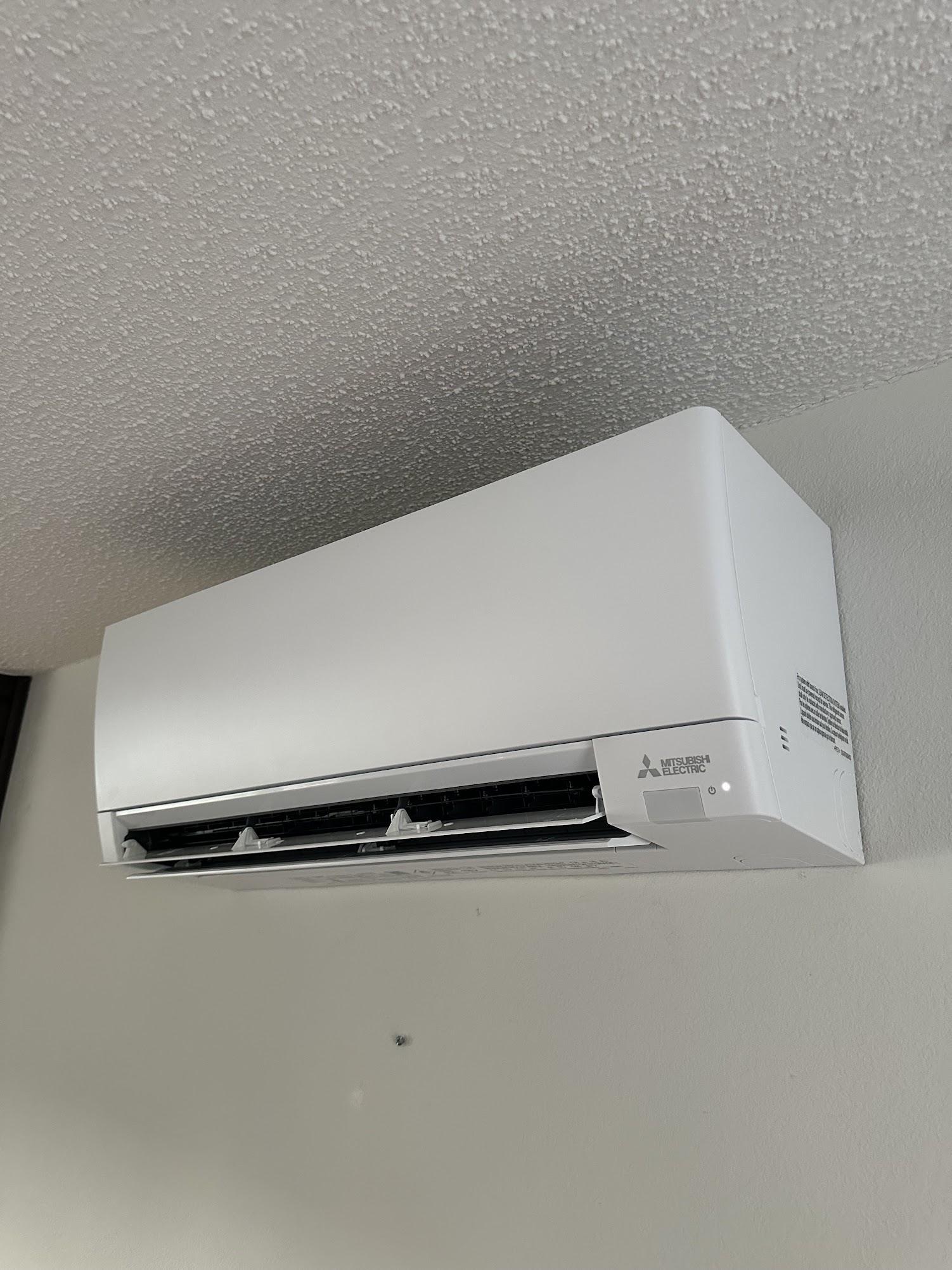Mitsubishi Electric wall-mount ductless mini-split indoor head installed by GreenFlow in a master bedroom in Gig Harbor as part of a tri-zone system